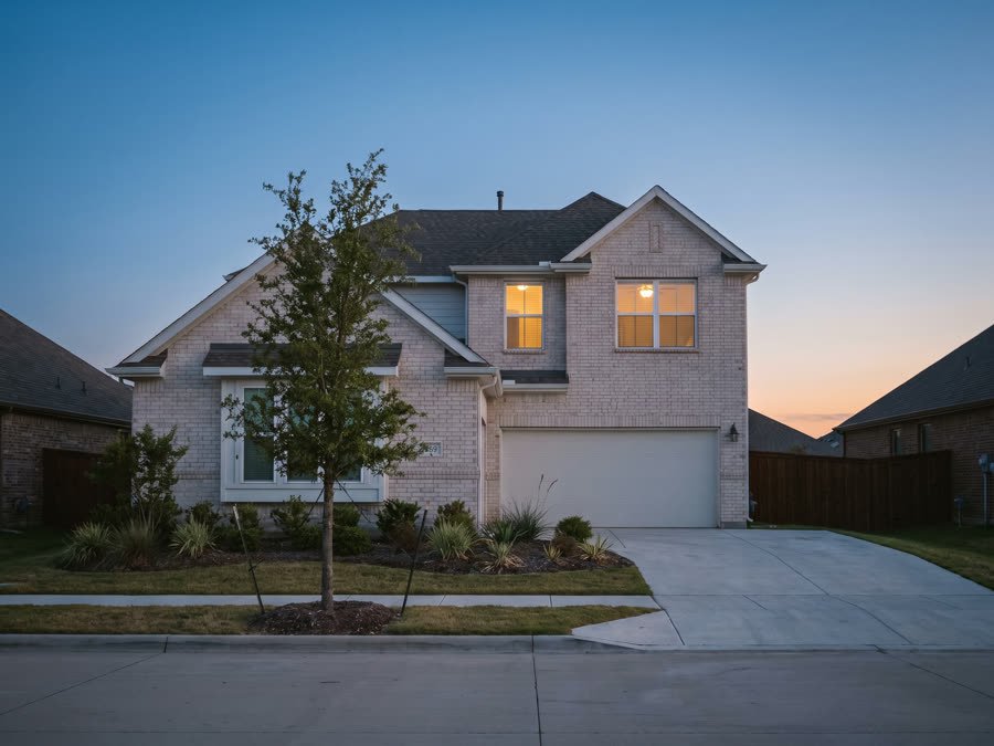 A two-storey home at dusk, managed in Prosper, Texas